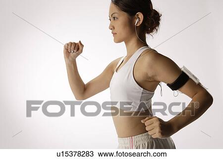 Stock Image - Close-up of a young woman exercising. Fotosearch