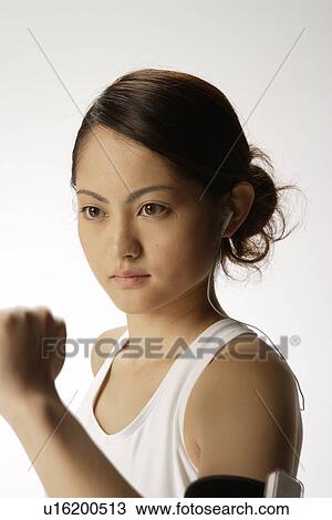Stock Image - Close-up of a young woman exercising. Fotosearch