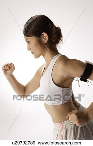 Stock Photo - Close-up of a young woman exercising. Fotosearch