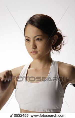Stock Photography - Close-up of a young woman exercising. Fotosearch