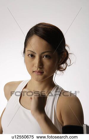 Stock Photography - Close-up of a young woman exercising. Fotosearch
