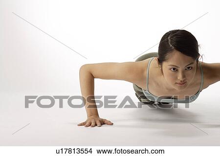 Portrait of a young woman exercising pushup View Large Photo Image Picture - Portrait of a young woman exercising pushup. Fotosearch
