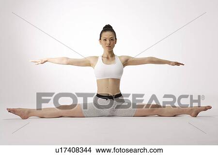 Portrait of a young woman stretching on the floor View Large Photo Image Picture - Portrait of a young woman stretching on the floor. Fotosearch