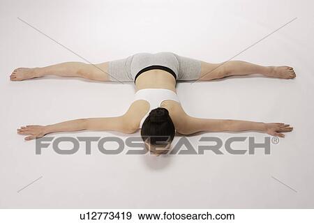 Rear view of young woman stretching View Large Photo Image Stock Photo - Rear view of young woman stretching. Fotosearch