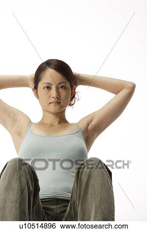 Stock Photograph - View of a young woman ding sit-up. Fotosearch