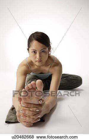 View of a young woman exercising on the floor View Large Photo Image Stock Photo - View of a young woman exercising on the floor. Fotosearch
