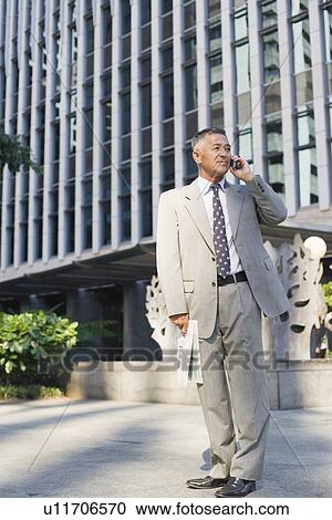 Businessman using mobile phone View Large Photo Image Stock Image - Businessman using mobile phone. Fotosearch