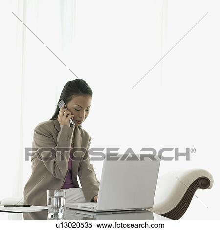Businesswoman talking on a mobile phone View Large Photo Image Stock Photography - Businesswoman talking on a mobile phone. Fotosearch