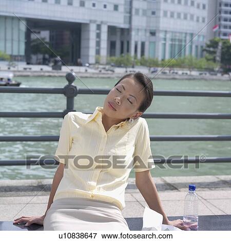 Stock Photo - Close-up of a businesswoman sitting with her eyes closed. Fotosearch