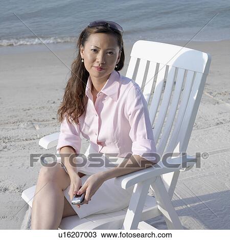 Portrait of a mid adult woman holding a mobile phone View Large Photo Image Stock Image - Portrait of a mid adult woman holding a mobile phone. Fotosearch