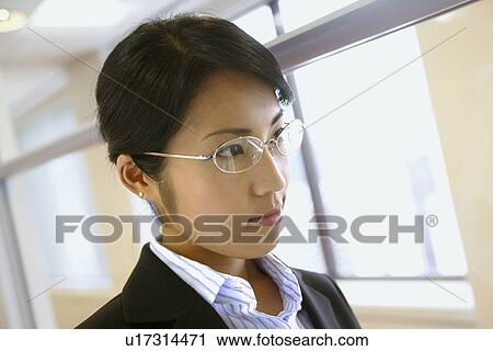 A side view of a woman wearing spectacles View Large Photo Image Stock Image - A side view of a woman wearing spectacles. Fotosearch
