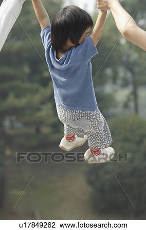Stock Image - A boy between mother and father. Fotosearch