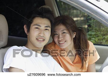 Stock Photograph - A couple in a car. Fotosearch