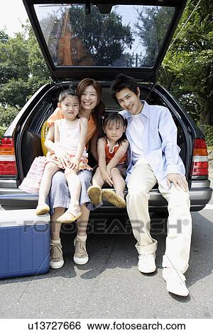 Stock Photograph - A family at the back of the van. Fotosearch