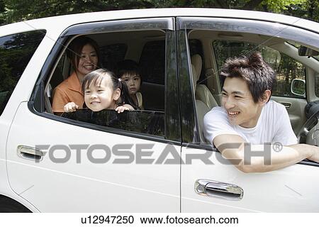 Stock Image - A family in a car. Fotosearch