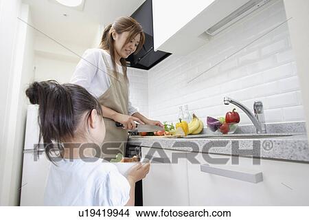 A mother and daughter in a kitchen View Large Photo Image Picture - A mother and daughter in a kitchen. Fotosearch