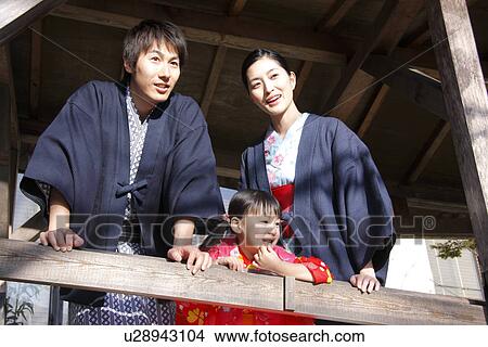 Picture - Family in Yukata looking outside, smiling. Fotosearch