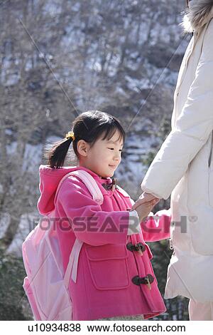 Girl holding mother's hand, smiling View Large Photo Image Stock Photo - Girl holding mother's hand, smiling. Fotosearch