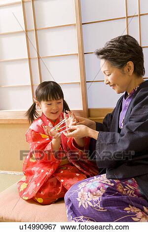 Girl in Yukata playing cat's cradle with grandmother View Large Photo Image Stock Photo - Girl in Yukata playing cat's cradle with grandmother. Fotosearch