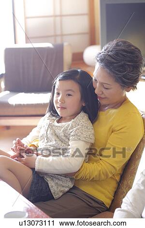 Stock Image - Girl with grandmother relaxing in the inn. Fotosearch
