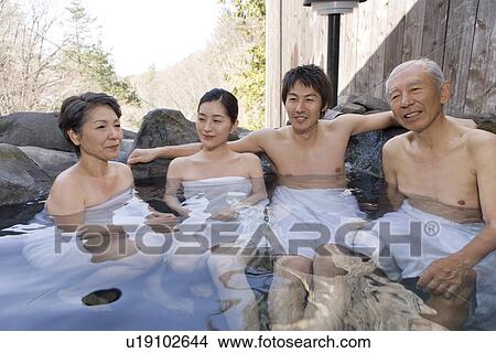 Picture - Multi-generation family in hot tub, smiling. Fotosearch