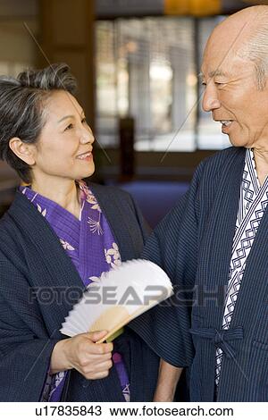 Stock Image - Senior couple in Yukata, smiling, blurred motion. Fotosearch