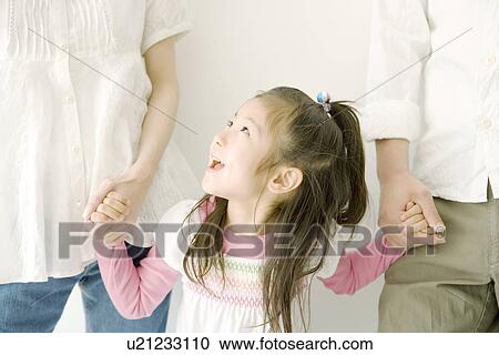 A Girl Holding Parents' Hands View Large Photo Image Stock Image - A Girl Holding Parents' Hands. Fotosearch