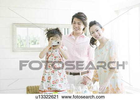 Stock Image - A Girl Taking Pictures. Fotosearch