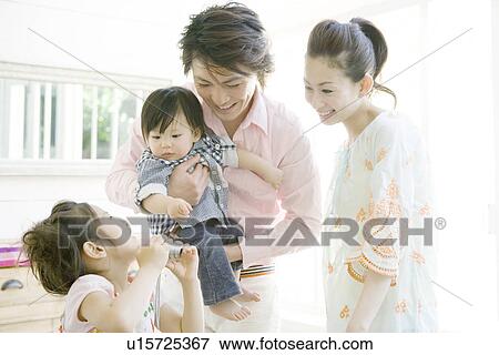 Stock Photo - Family Looking at Digital Camera. Fotosearch