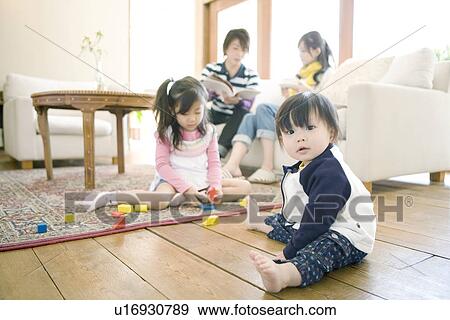 Stock Photo - Family of Four in the Living Room. Fotosearch