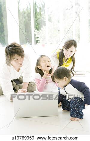 Family of Four in the Living Room View Large Photo Image Stock Photo - Family of Four in the Living Room. Fotosearch