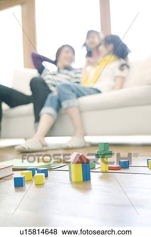 Stock Photo - Family of Three in the Living Room. Fotosearch