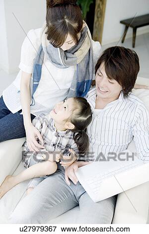 Family of Three in the Living Room View Large Photo Image Stock Photo - Family of Three in the Living Room. Fotosearch