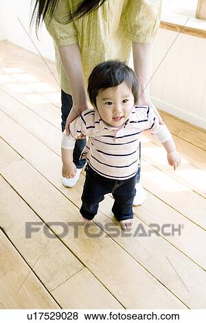 Stock Photo - Walking Baby with Mother. Fotosearch