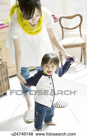 Stock Photo - Walking Baby with Mother. Fotosearch
