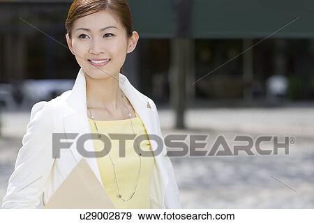 Stock Photo - A Woman Holding an Envelope. Fotosearch