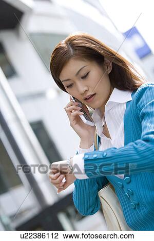 A Woman Looking at Watch View Large Photo Image Stock Image - A Woman Looking at Watch. Fotosearch