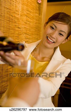 Stock Photo - A Woman Pouring Beer. Fotosearch