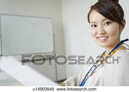 Stock Photography - A Woman Smiling at a Meeting Room. Fotosearch