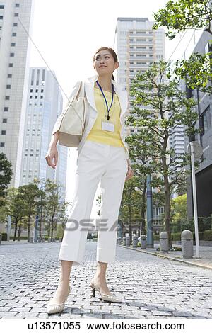 Stock Photography - A Woman Standing in the Business District. Fotosearch