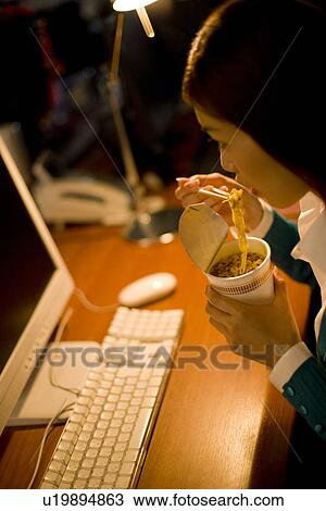 Stock Image - A Woman Working in the Office. Fotosearch