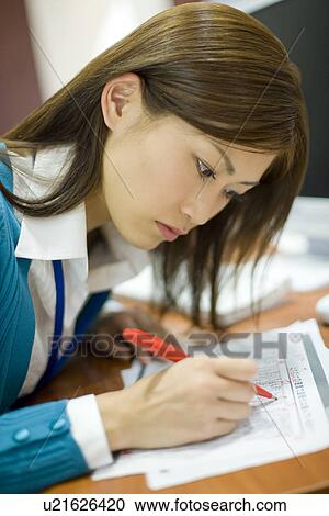 Stock Image - A Woman Working in the Office. Fotosearch