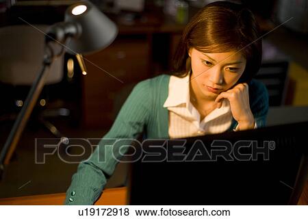 Stock Photo - A Woman Working in the Office. Fotosearch