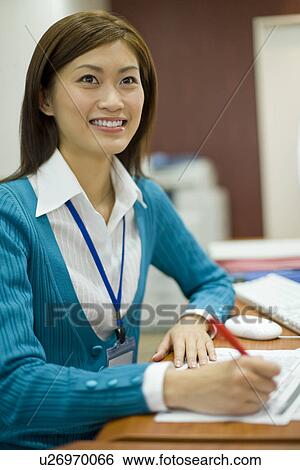 Stock Photograph - A Woman Working in the Office. Fotosearch