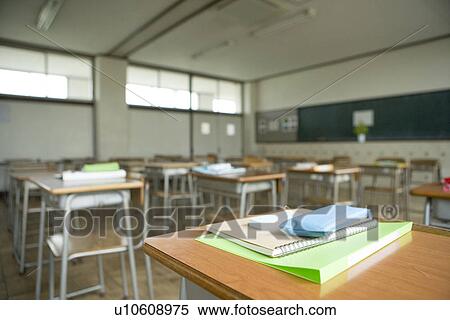 Stock Photography - Empty classroom, note pads on desk. Fotosearch
