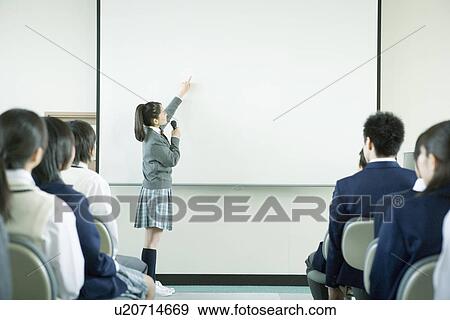 Stock Photo - Girl giving presentation in class. Fotosearch