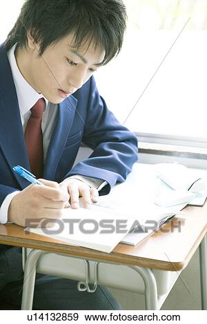 Stock Photo - High school student studying in classroom. Fotosearch