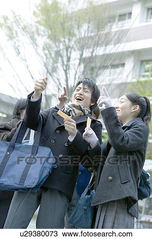 Stock Image - High school students in campus, smiling. Fotosearch