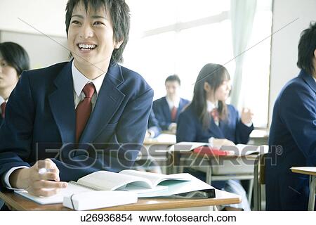 Picture - High school students in classroom, smiling. Fotosearch