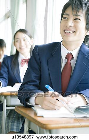 Stock Photo - High school students in classroom, smiling. Fotosearch